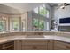 Open kitchen with stainless steel dishwasher, marble countertops and view to the living room at 320 N Drew Ct, Duluth, GA 30097