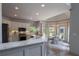 Open kitchen with stainless steel appliances, marble countertops and view to the breakfast area at 320 N Drew Ct, Duluth, GA 30097