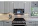 Kitchen features stainless steel KitchenAid appliances and marble countertops at 320 N Drew Ct, Duluth, GA 30097