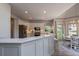 Open kitchen with stainless steel appliances, marble countertops and view to the breakfast area at 320 N Drew Ct, Duluth, GA 30097