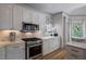 Kitchen features stainless steel KitchenAid appliances and marble countertops at 320 N Drew Ct, Duluth, GA 30097