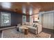 Living room with wood ceiling, a sectional sofa, and large windows at 320 N Drew Ct, Duluth, GA 30097