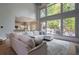 Bright living room with soaring ceilings, a large sectional, and an adjacent kitchen at 320 N Drew Ct, Duluth, GA 30097