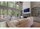 Sun-filled living room featuring built-in bookshelves and outdoor views at 320 N Drew Ct, Duluth, GA 30097
