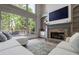 Inviting living room features a stone fireplace, large windows, and a plush sofa at 320 N Drew Ct, Duluth, GA 30097