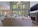 Bright living room with a stone fireplace, large windows, and deck access at 320 N Drew Ct, Duluth, GA 30097
