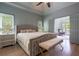 Comfortable main bedroom features decorative ceiling fan, bench, and ensuite bath access at 320 N Drew Ct, Duluth, GA 30097
