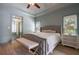 Relaxing main bedroom with decorative ceiling fan, hardwood floor, and ensuite access at 320 N Drew Ct, Duluth, GA 30097