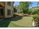 Well-maintained backyard putting green with stone accents and mature landscaping at 320 N Drew Ct, Duluth, GA 30097