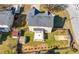 Aerial view of a fenced backyard with a covered patio, storage sheds, and a well-maintained lawn at 401 Windstream Sw Dr, Marietta, GA 30060