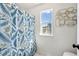 Bright bathroom with floral shower curtain and natural light at 401 Windstream Sw Dr, Marietta, GA 30060