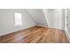 Lofted bedroom featuring angled ceiling, wood floors, window and closet at 401 Windstream Sw Dr, Marietta, GA 30060
