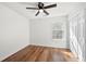 This bedroom features a ceiling fan, wood floors, and a window offering natural light at 401 Windstream Sw Dr, Marietta, GA 30060