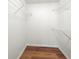Walk-in closet with vinyl floors and built-in wire shelving for optimal storage at 401 Windstream Sw Dr, Marietta, GA 30060