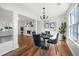 Elegant dining room with modern decor, chandelier, and views into the bright living area at 401 Windstream Sw Dr, Marietta, GA 30060