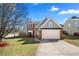 Charming two-story home with a well-manicured lawn, landscaping, and a two-car garage at 401 Windstream Sw Dr, Marietta, GA 30060