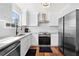 Modern kitchen features white cabinets, stainless steel appliances, and granite countertops at 401 Windstream Sw Dr, Marietta, GA 30060