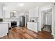 Bright kitchen featuring stainless steel appliances, white cabinets, and hardwood floors at 401 Windstream Sw Dr, Marietta, GA 30060