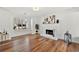 Bright living room with a white brick fireplace, wood floors, and modern decor at 401 Windstream Sw Dr, Marietta, GA 30060