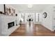 Spacious living room featuring a white brick fireplace, modern lighting, and wood flooring at 401 Windstream Sw Dr, Marietta, GA 30060