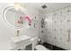 Modern bathroom featuring geometric tile shower, floating shelves, and lighted vanity mirror at 130 26Th Nw St # 807, Atlanta, GA 30309