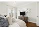 Bedroom with private balcony, decorative mirrors and lighting, and hardwood flooring at 130 26Th Nw St # 807, Atlanta, GA 30309