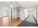 Hallway with elevators and hardwood floors, leading to exterior view through glass doors at 130 26Th Nw St # 807, Atlanta, GA 30309