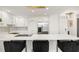 Modern kitchen features bar seating, marble backsplash, stainless appliances, and contemporary lighting fixtures at 130 26Th Nw St # 807, Atlanta, GA 30309