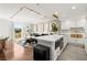 Open concept kitchen showcasing stainless appliances, an island with seating, and seamless flow to the living area at 130 26Th Nw St # 807, Atlanta, GA 30309