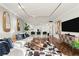 Bright living space offering a modern sectional sofa, decorative mirrors, and open access to the kitchen area at 130 26Th Nw St # 807, Atlanta, GA 30309
