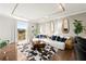 Open-concept living room featuring a large sectional sofa, decorative mirrors, and an inviting atmosphere at 130 26Th Nw St # 807, Atlanta, GA 30309