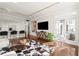 Spacious living area connecting to the kitchen, featuring modern decor, hardwood floors, and ample natural light at 130 26Th Nw St # 807, Atlanta, GA 30309
