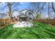 Backyard view showcasing a well-manicured lawn and custom patio with built in seating at 1604 Temple Ave, Atlanta, GA 30337
