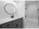 Bathroom featuring a vanity with modern fixtures and a tiled shower-tub combination at 1604 Temple Ave, Atlanta, GA 30337