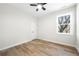 Bright bedroom featuring wood flooring, a ceiling fan, and a window letting in natural light at 1604 Temple Ave, Atlanta, GA 30337
