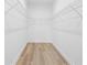 Walk-in closet with custom wire shelving and hardwood floor at 1604 Temple Ave, Atlanta, GA 30337
