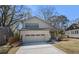 New construction home featuring a two-car garage and stylish brick and siding exterior at 1604 Temple Ave, Atlanta, GA 30337