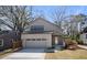 Charming two-story home with a brick and siding exterior, landscaped yard and large driveway at 1604 Temple Ave, Atlanta, GA 30337
