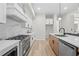 Modern kitchen with stainless appliances, marble backsplash and an island with breakfast bar at 1604 Temple Ave, Atlanta, GA 30337