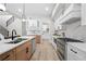 Open kitchen featuring stainless steel appliances, custom white cabinetry, and breakfast bar area at 1604 Temple Ave, Atlanta, GA 30337