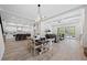 Open-concept living space with wood floors, recessed lighting, and a modern kitchen with stainless appliances at 1604 Temple Ave, Atlanta, GA 30337