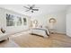 Sun-lit main bedroom with large windows, ceiling fan, hardwood floors, and neutral decor at 1604 Temple Ave, Atlanta, GA 30337
