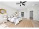 Main bedroom with neutral walls, ceiling fan, wooden floor and walk in closet at 1604 Temple Ave, Atlanta, GA 30337