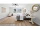 Bright main bedroom with three large windows, ceiling fan, wooden floors, and neutral decor at 1604 Temple Ave, Atlanta, GA 30337