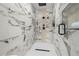 Modern shower featuring white marble tile, shower and overhead rain shower at 1604 Temple Ave, Atlanta, GA 30337