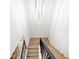 Modern staircase with black railings, bright lighting, and hardwood floors leading to other levels at 1604 Temple Ave, Atlanta, GA 30337