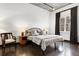 Spacious bedroom with natural light and dark hardwood floors features modern furniture and fixtures at 206 11Th Ne St # 205, Atlanta, GA 30309