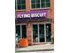 A red brick two-story restaurant with large windows and a purple sign at 206 11Th Ne St # 205, Atlanta, GA 30309
