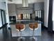 This kitchen has modern appliances and cabinets, stainless steel backsplash, and dark wood floors at 206 11Th Ne St # 205, Atlanta, GA 30309
