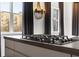 Gourmet kitchen cooktop has exterior view from the windows and chandelier accent lighting at 206 11Th Ne St # 205, Atlanta, GA 30309